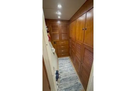 Slide: The Image of Interior hallway of 2006 Endeavour 44 TrawlerCat with wooden cabinets and soft lighting. - 20