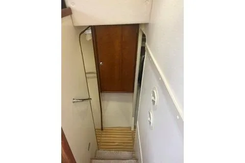Slide: The Image of Stairway inside 2006 Endeavour 44 TrawlerCat, featuring wooden steps and a narrow passage. - 22