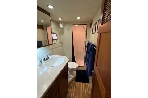 Slide: The Image of Bathroom interior of 2006 Endeavour 44 TrawlerCat with modern fixtures and wooden accents. - 25