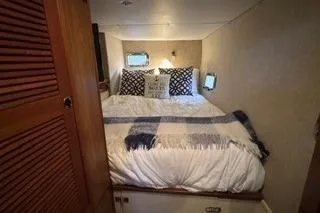 Slide: The Image of Cozy bedroom in 2006 Endeavour 44 TrawlerCat with nautical decor and soft lighting. - 27