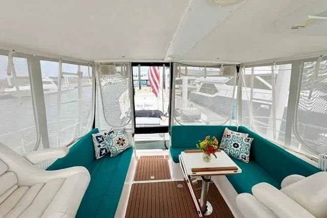 Slide: The Image of Interior of 2006 Endeavour 44 TrawlerCat with teal seating and decorative pillows. - 3