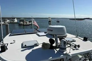 Slide: The Image of 2006 Endeavour 44 TrawlerCat on water, featuring navigation equipment and solar panels. - 33