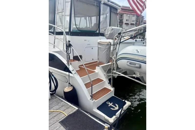 Slide: The Image of Stern view of 2006 Endeavour 44 TrawlerCat with steps and docked inflatable boat. - 36