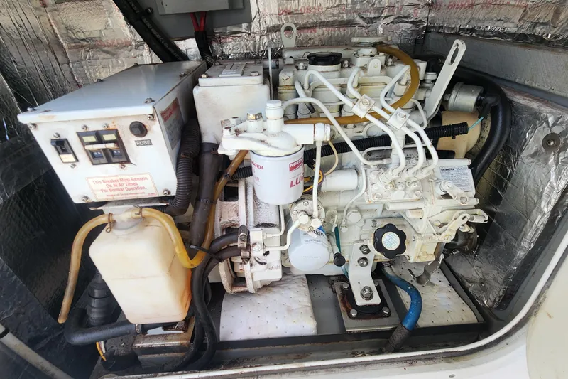 Slide: The Image of Engine compartment of a 2006 Endeavour 44 TrawlerCat, showcasing mechanical components and wiring. - 42