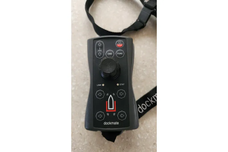Slide: The Image of Dockmate remote control for Endeavour 44 TrawlerCat 2006, featuring joystick and buttons. - 44