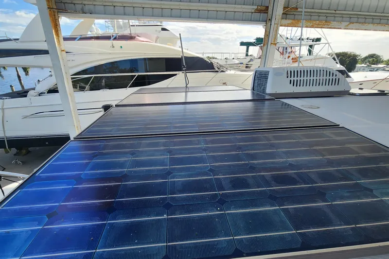 Slide: The Image of Solar panels on 2006 Endeavour 44 TrawlerCat, docked with other boats in marina. - 47