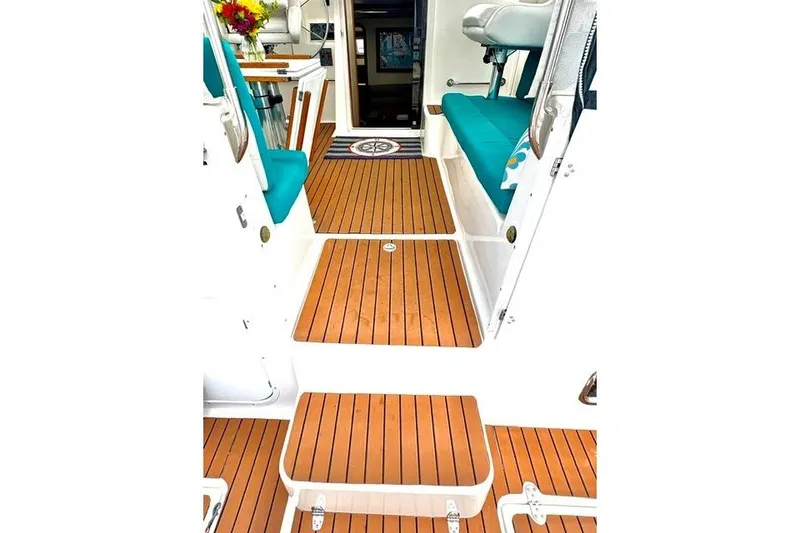 Slide: The Image of Interior of 2006 Endeavour 44 TrawlerCat with teak flooring and teal seating. - 5