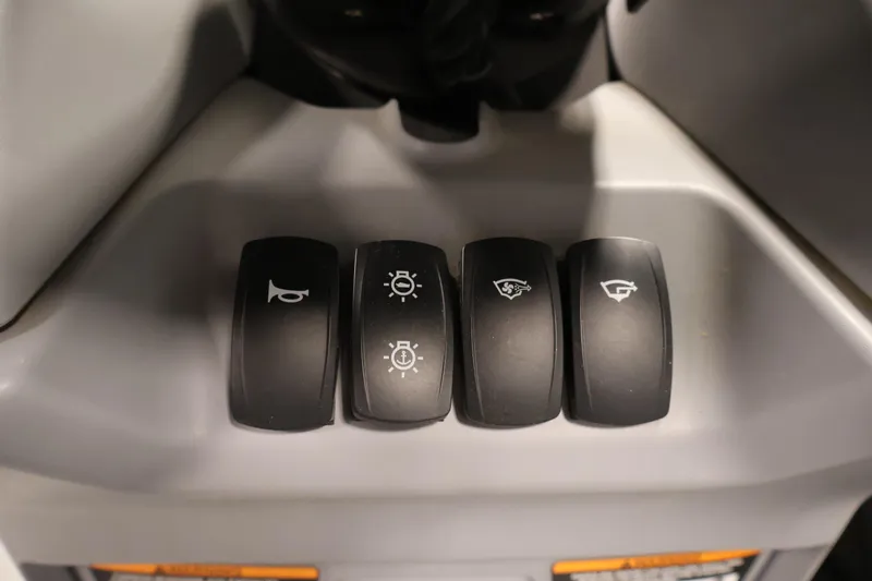 Slide: The Image of Control panel switches on a 2023 Sea-Doo Switch Cruise 21 boat. - 21