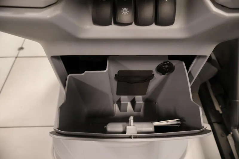 Slide: The Image of Storage compartment of 2023 Sea-Doo Switch Cruise 21 with control buttons above. - 22