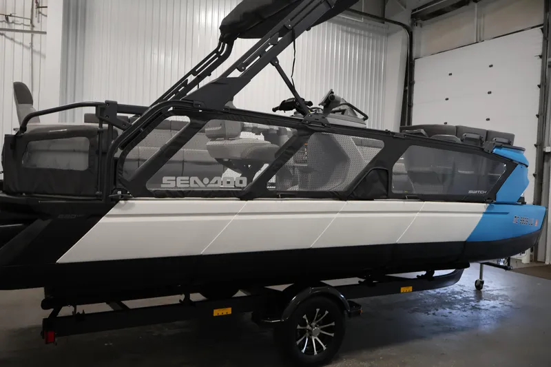 Slide: The Image of 2023 Sea-Doo Switch Cruise 21 pontoon boat in a garage setting. - 4