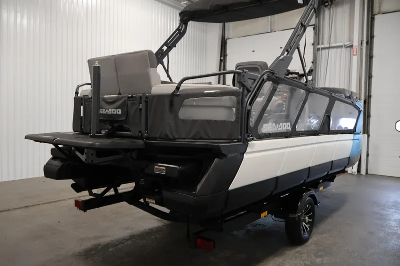 Slide: The Image of 2023 Sea-Doo Switch Cruise 21 pontoon boat in a garage setting. - 5
