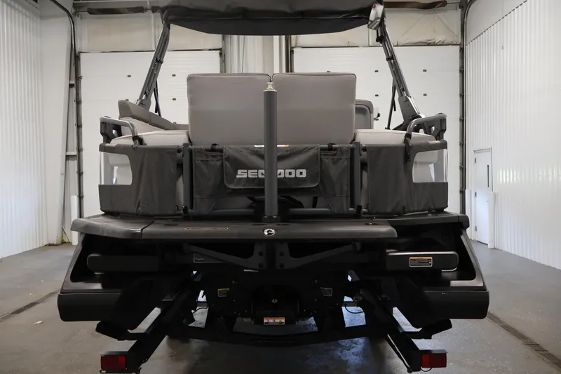 Slide: The Image of 2023 Sea-Doo Switch Cruise 21, rear view in a garage setting. - 6