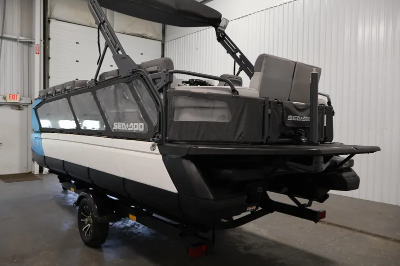 Slide: The Image of 2023 Sea-Doo Switch Cruise 21 pontoon boat in a garage setting. - 7