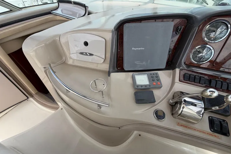 Slide: The Image of 2003 Sea Ray 420 Sundancer helm with Raymarine navigation and control panel. - 12