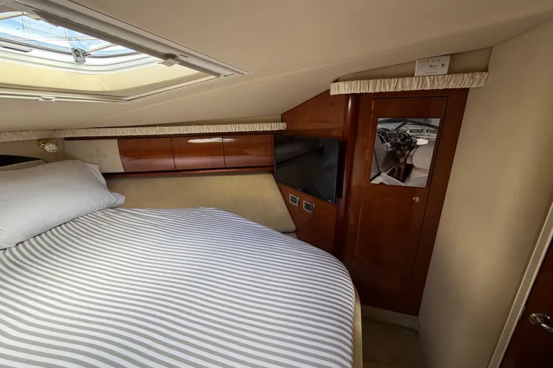 Slide: The Image of Luxurious cabin interior of 2003 Sea Ray 420 Sundancer yacht with striped bedding. - 17