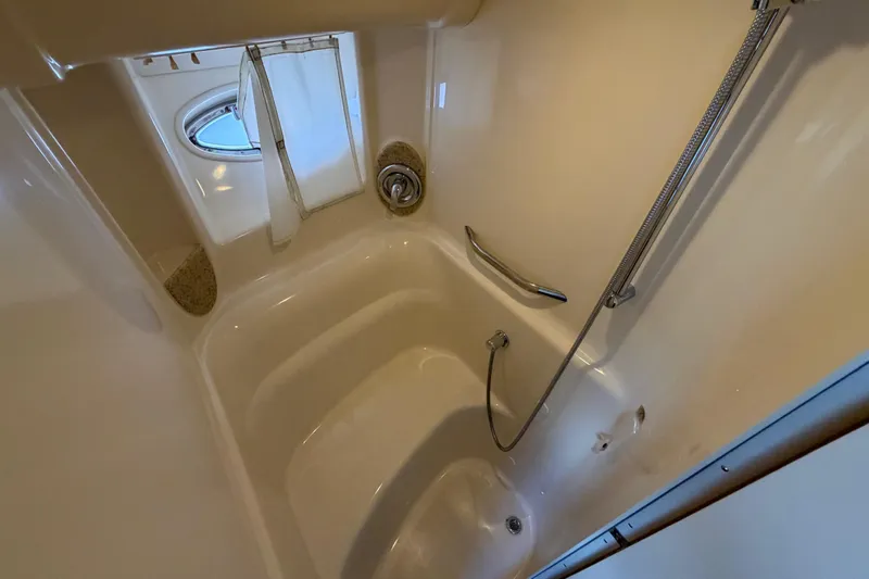 Slide: The Image of Bathroom interior of 2003 Sea Ray 420 Sundancer yacht with shower and porthole window. - 23