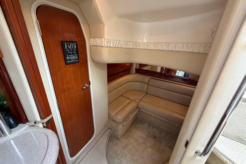 Slide: The Image of Interior of 2003 Sea Ray 420 Sundancer yacht with beige seating and wooden door. - 25