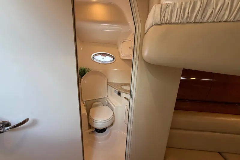 Slide: The Image of Interior of 2003 Sea Ray 420 Sundancer yacht bathroom with toilet and porthole window. - 27