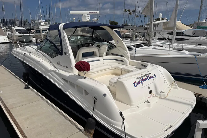 Slide: The Image of 2003 Sea Ray 420 Sundancer yacht docked at marina, featuring sleek design and spacious deck. - 3