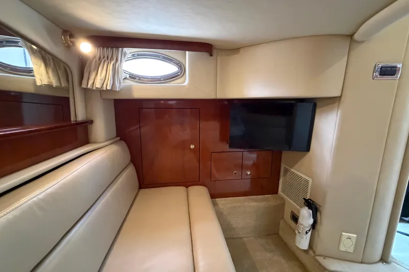 Slide: The Image of Interior of 2003 Sea Ray 420 Sundancer yacht with seating, TV, and porthole window. - 30