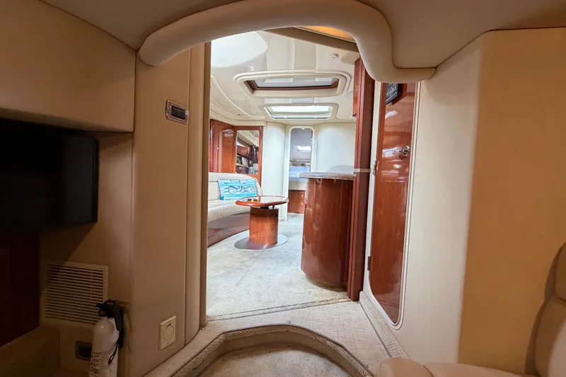 Slide: The Image of Interior of 2003 Sea Ray 420 Sundancer yacht, featuring elegant wood finishes and cozy seating. - 32