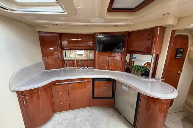 Slide: The Image of Luxurious 2003 Sea Ray 420 Sundancer yacht interior with elegant wood cabinetry and modern amenities. - 34