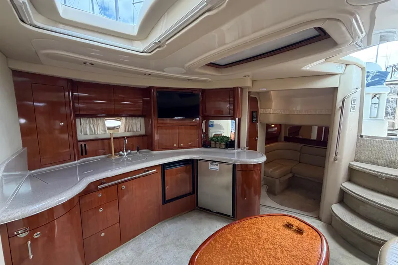 Slide: The Image of Luxurious interior of 2003 Sea Ray 420 Sundancer yacht with modern kitchen and seating area. - 35
