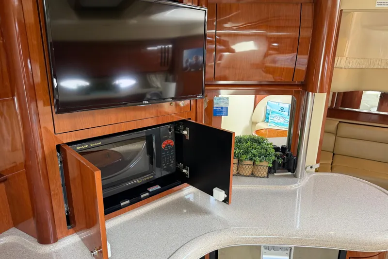 Slide: The Image of Interior of 2003 Sea Ray 420 Sundancer with TV, microwave, and elegant wood cabinetry. - 36