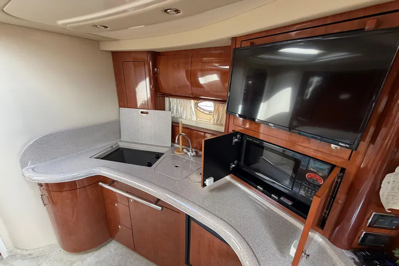 Slide: The Image of Luxurious 2003 Sea Ray 420 Sundancer yacht interior with modern kitchen and entertainment setup. - 37