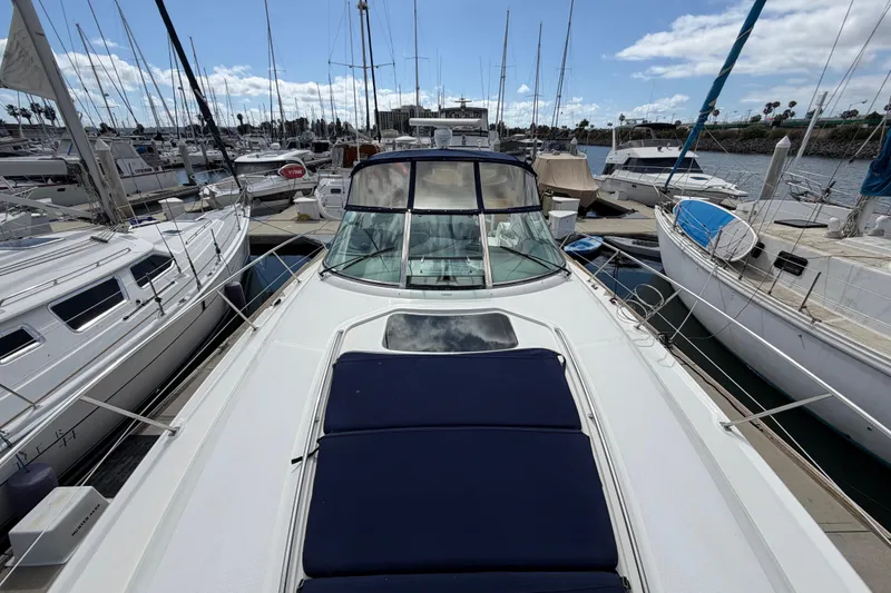 Slide: The Image of 2003 Sea Ray 420 Sundancer yacht docked among sailboats in a marina. - 38