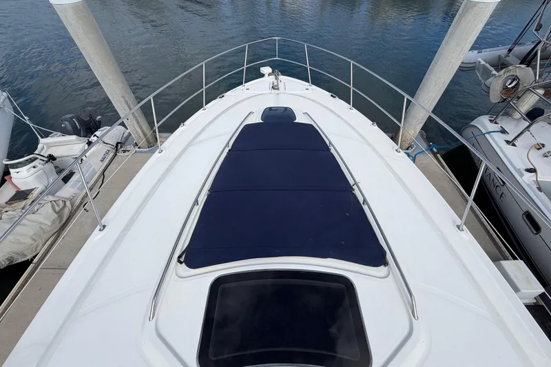 Slide: The Image of 2003 Sea Ray 420 Sundancer yacht docked, featuring spacious deck and sleek design. - 39