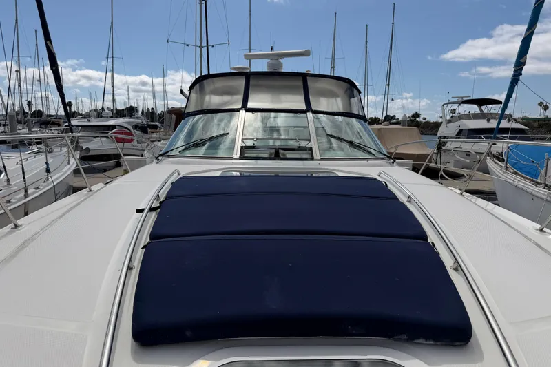 Slide: The Image of 2003 Sea Ray 420 Sundancer yacht docked at marina with blue cushions. - 42