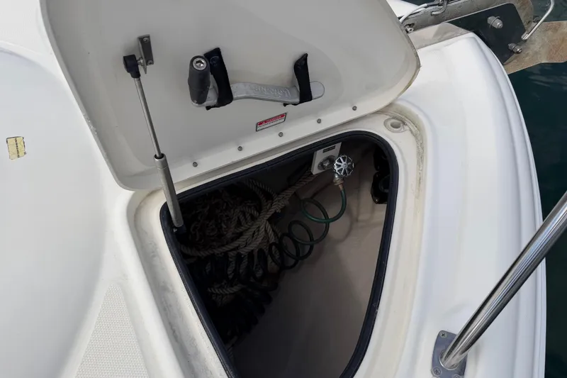 Slide: The Image of Open storage compartment on 2003 Sea Ray 420 Sundancer boat, containing ropes and equipment. - 43