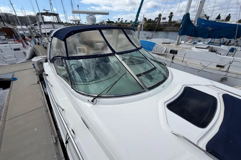 Slide: The Image of 2003 Sea Ray 420 Sundancer docked at marina, featuring sleek design and spacious deck. - 44