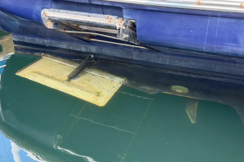 Slide: The Image of Close-up of a 2003 Sea Ray 420 Sundancer's trim tab in water. - 47
