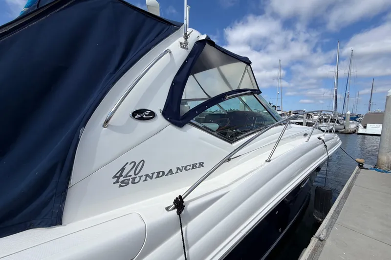 Slide: The Image of 2003 Sea Ray 420 Sundancer yacht docked at marina under blue sky. - 49