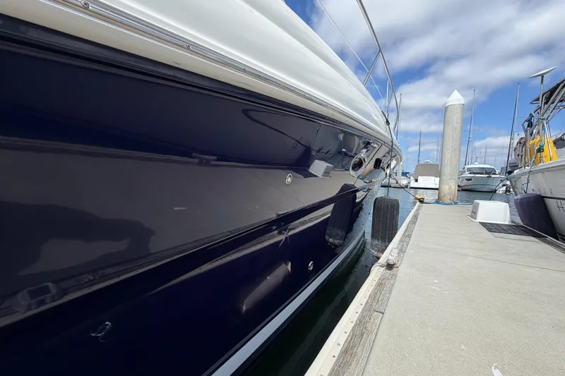 Slide: The Image of 2003 Sea Ray 420 Sundancer yacht docked at marina under blue sky. - 50