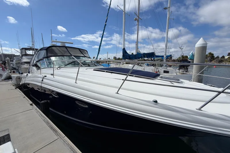 Slide: The Image of 2003 Sea Ray 420 Sundancer yacht docked at marina under blue sky. - 51