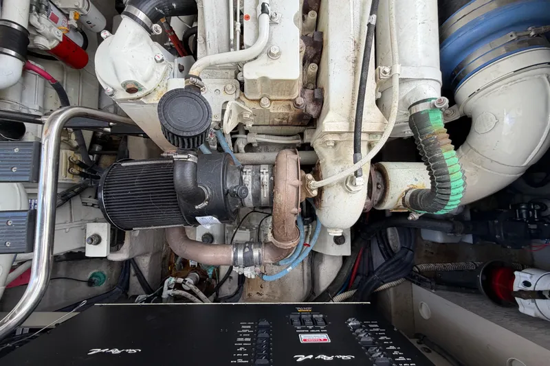 Slide: The Image of Engine compartment of a 2003 Sea Ray 420 Sundancer boat, showcasing mechanical components. - 53