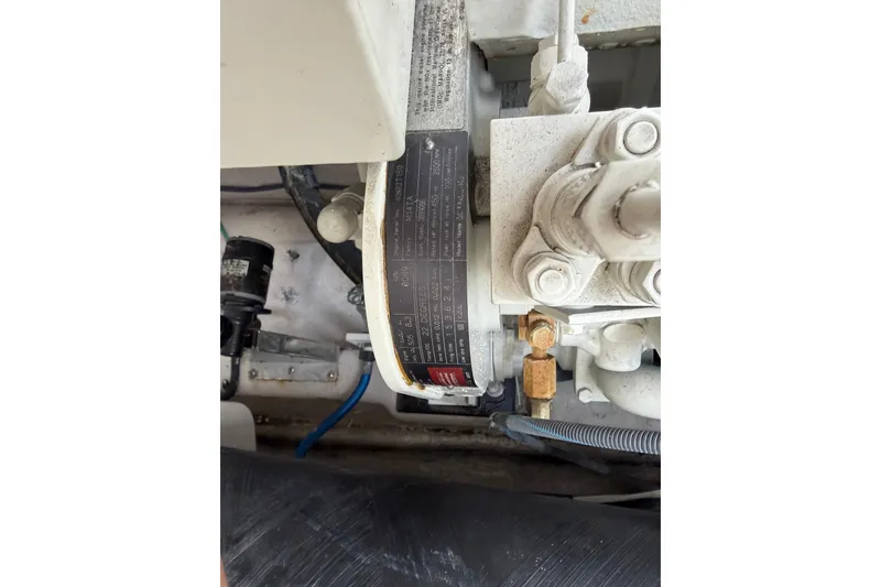 Slide: The Image of Engine compartment of a 2003 Sea Ray 420 Sundancer boat, showing mechanical components. - 55