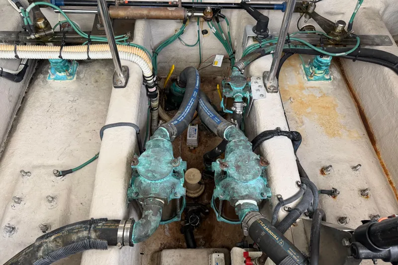 Slide: The Image of Engine compartment of a 2003 Sea Ray 420 Sundancer with visible hoses and fittings. - 56