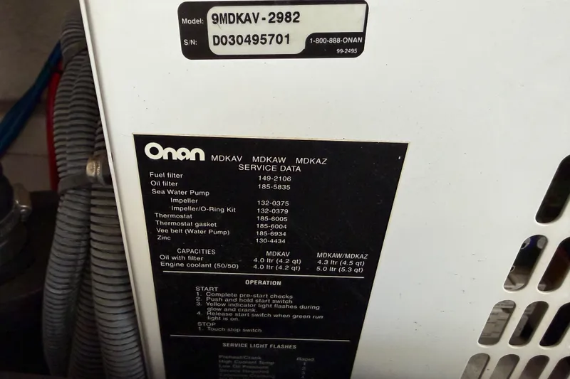 Slide: The Image of Onan generator service data panel on a 2003 Sea Ray 420 Sundancer boat. - 58
