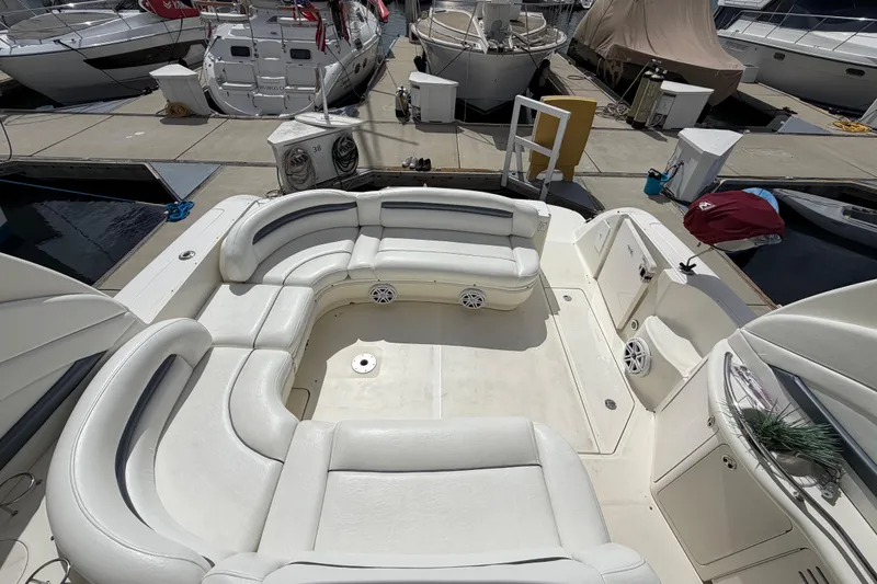 Slide: The Image of 2003 Sea Ray 420 Sundancer yacht with spacious white seating at a marina. - 6