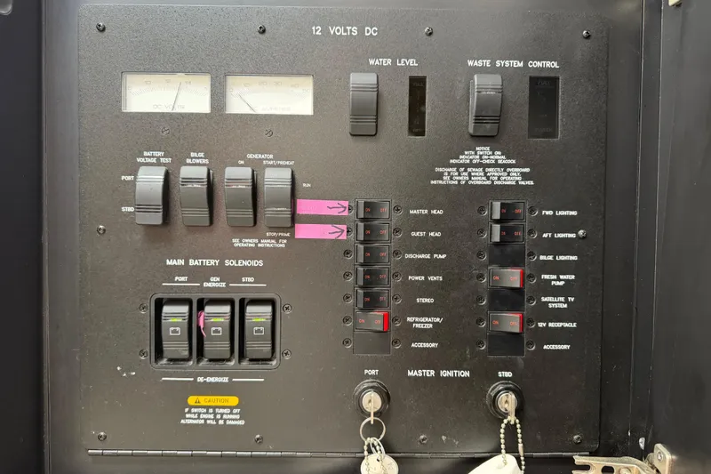 Slide: The Image of Control panel of a 2003 Sea Ray 420 Sundancer boat, featuring switches and gauges. - 62