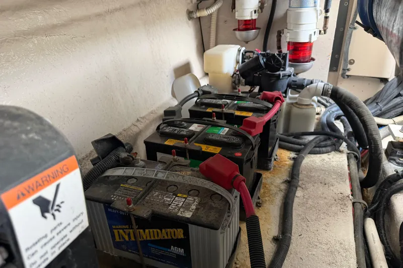 Slide: The Image of Battery compartment of a 2003 Sea Ray 420 Sundancer with wiring and warning labels. - 65