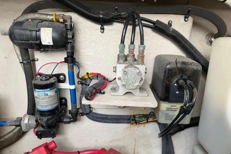Slide: The Image of Engine compartment of a 2003 Sea Ray 420 Sundancer with various mechanical components. - 66