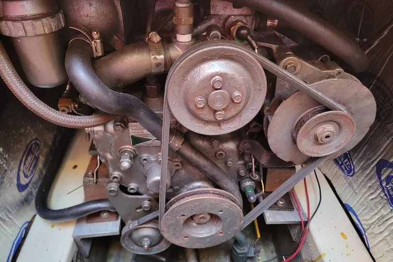 Slide: The Image of Engine of a 1986 Pearson 28 sailboat, featuring belts and pulleys. - 10
