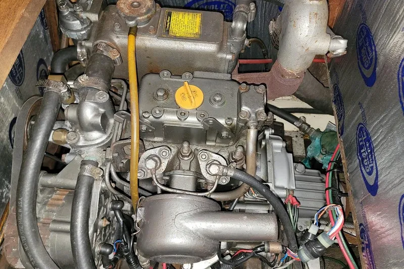 Slide: The Image of Engine of a 1986 Pearson 28 sailboat, showcasing mechanical components and wiring. - 13