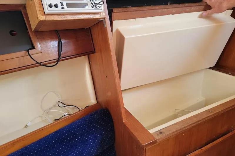 Slide: The Image of Interior of a 1986 Pearson 28 sailboat showing storage compartments and electronic equipment. - 16