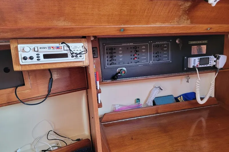 Slide: The Image of 1986 Pearson 28 sailboat interior with radio and control panels. - 17